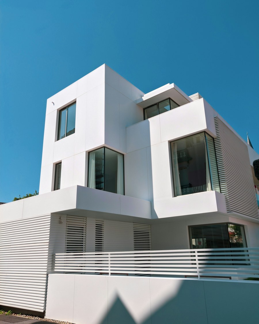 Modern whitewashed villa exterior against a blue sky in Ibiza